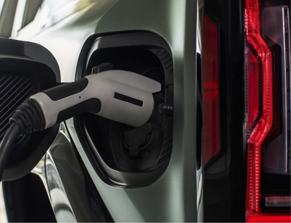 Close up of charging port with charger plugged in on a GMC Hummer EV SUV - My Car GMC in Millersburg PA